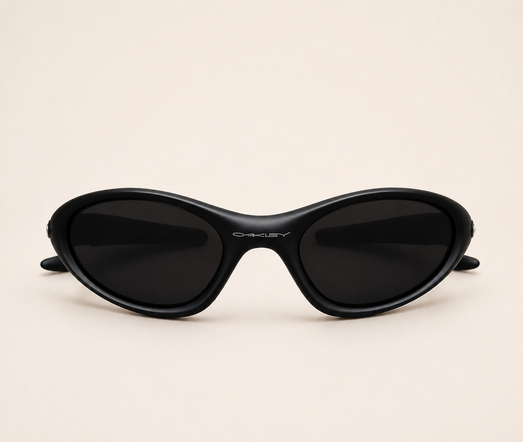 Front view of black Oakley Minute sunglasses with dark lenses and a curved wraparound frame.